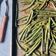 green beans on a sheet pan with a spatula next to it