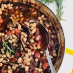 cassoulet in a large baking dish with a serving spoon in it