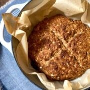 baked Irish soda bread with an x pattern on top in a Dutch oven