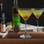 Chartreuse cocktail on wood table.