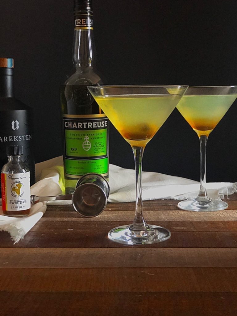 Chartreuse cocktail on wood table.