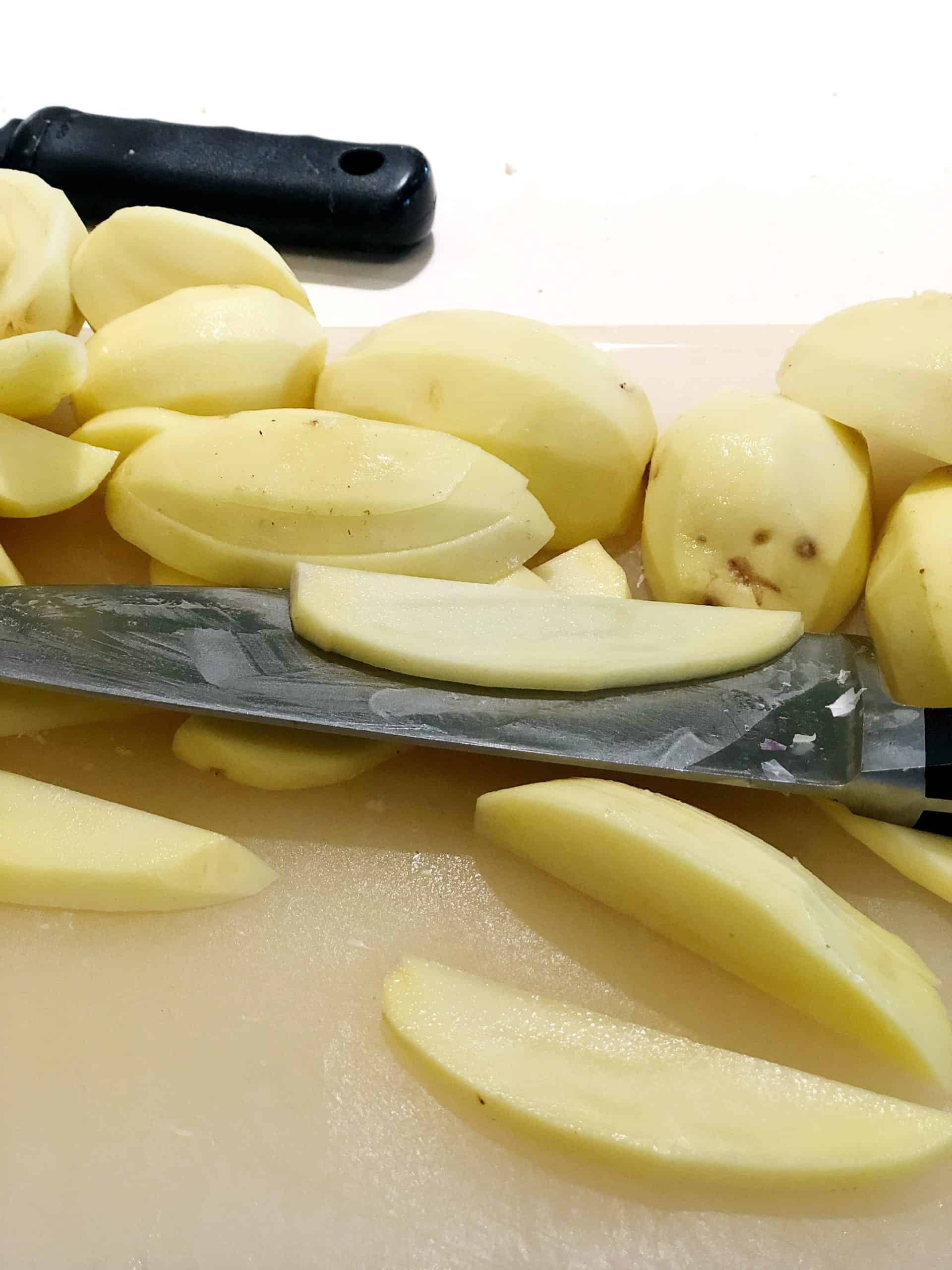 sliced potatoes on a cutting board