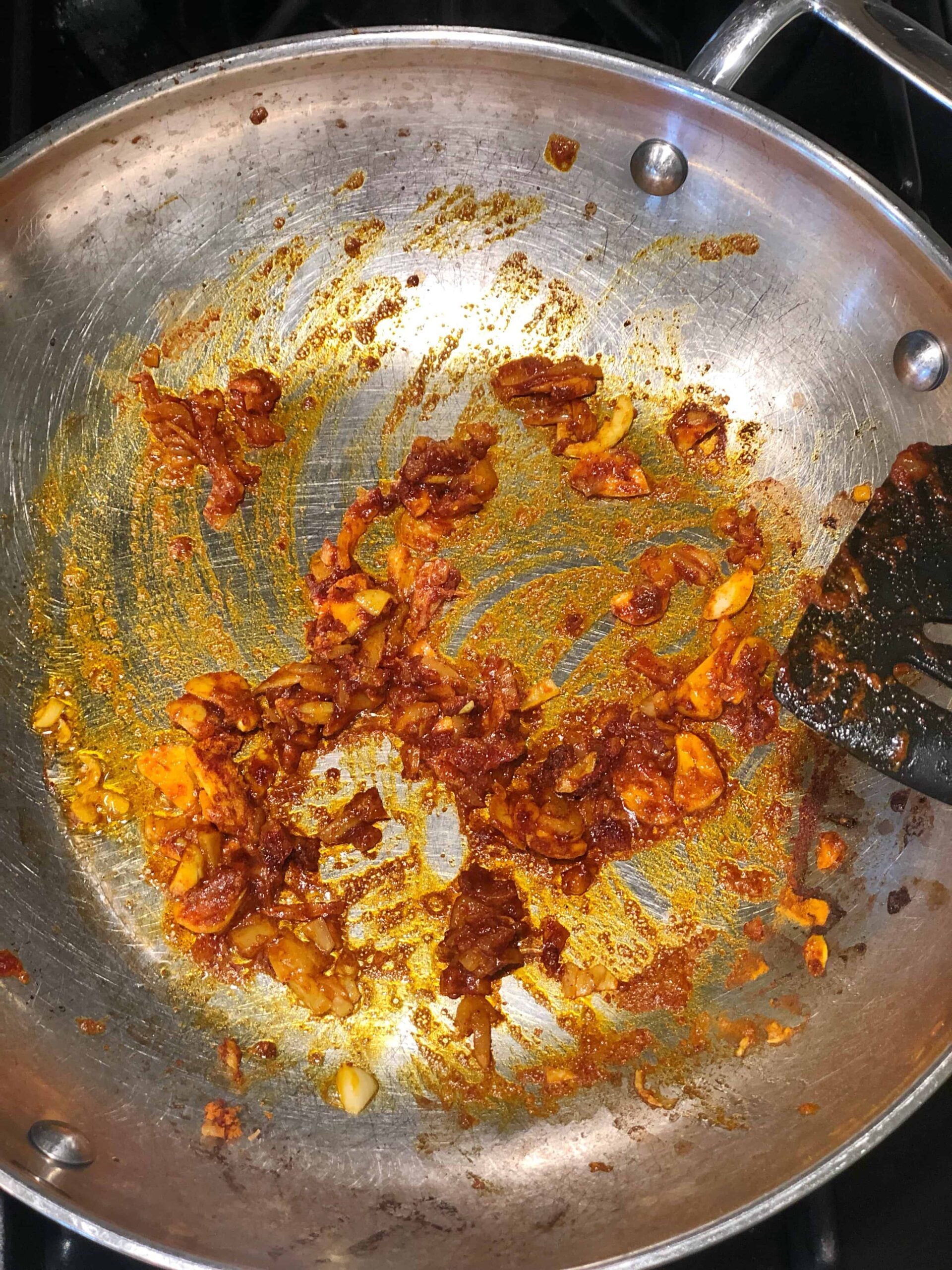 turmeric spices cooking in a saute pan.