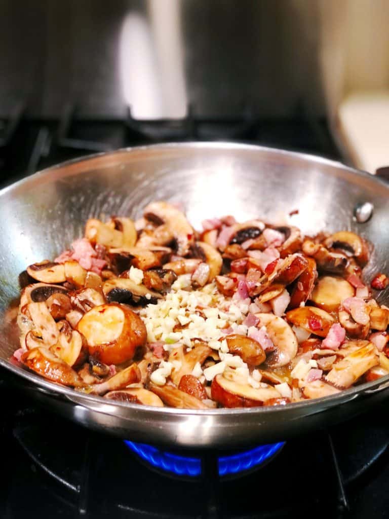 Pancetta and Mushrooms cooking in pan.