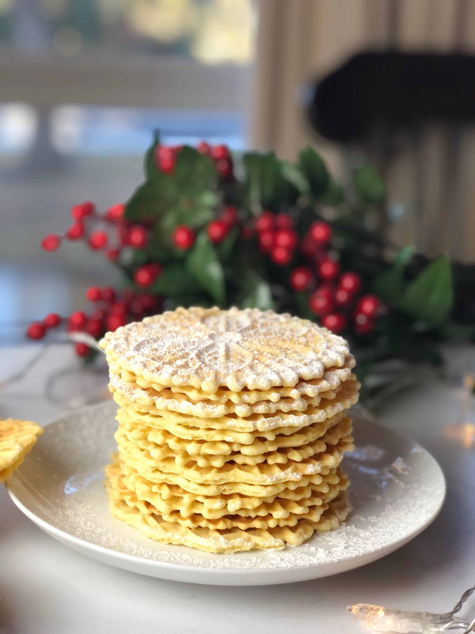 pizzelle cookies on a plate stacked up