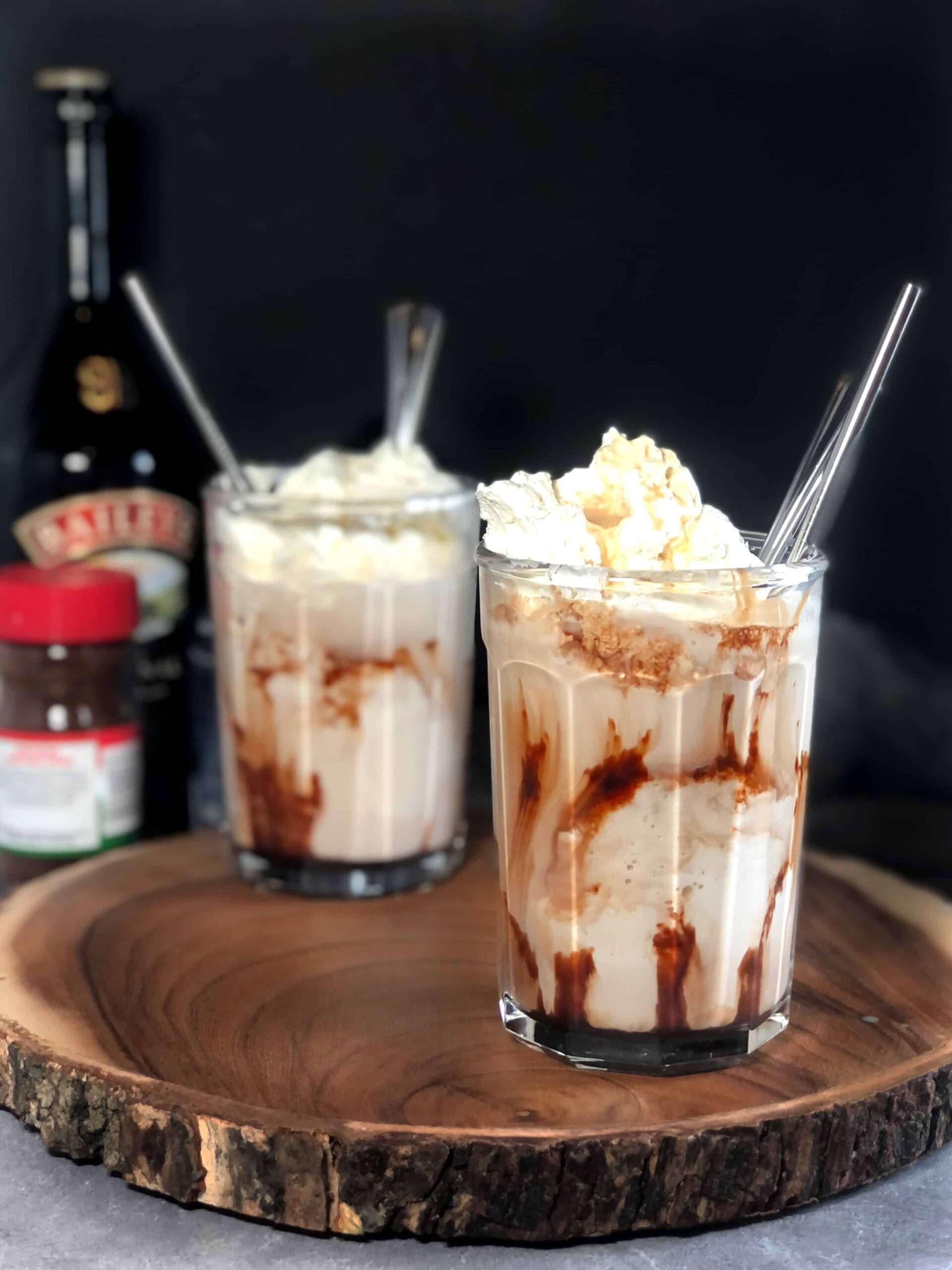Two Baileys Milkshakes with Baileys in background