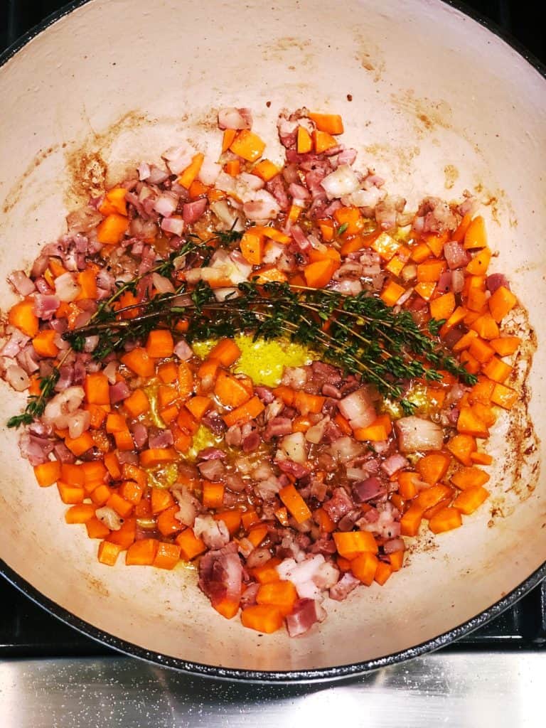 adding herbs to genovese sauce