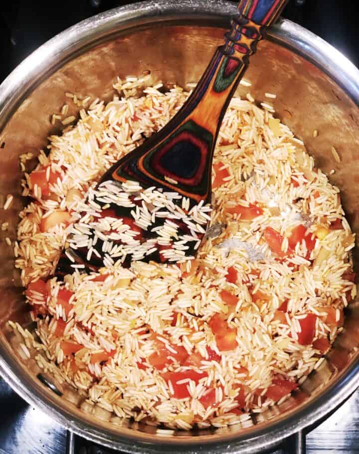 adding flavor to Spanish rice