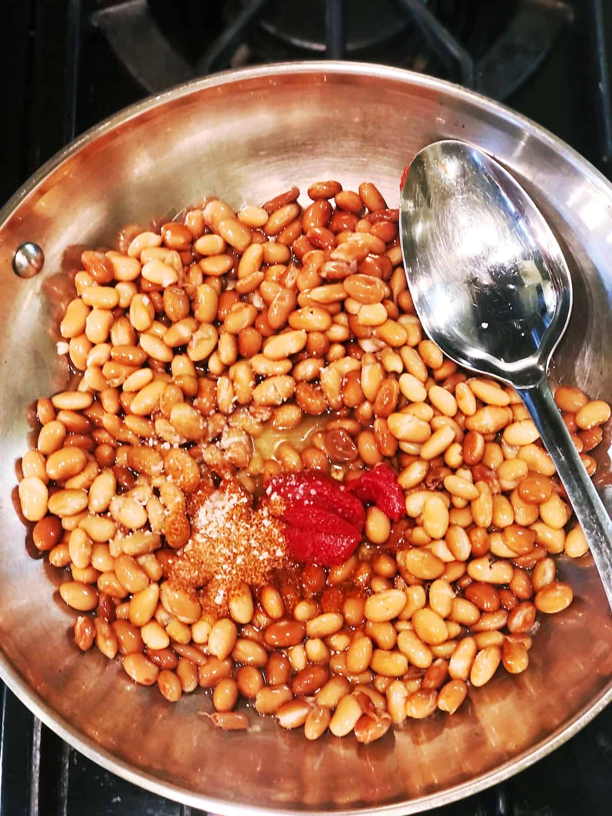 adding seasoning to pinto beans