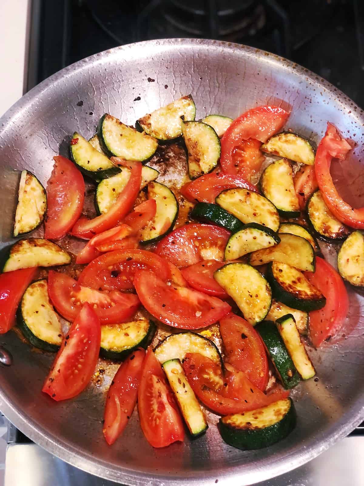 fresh tomatoes in pan with zucchini