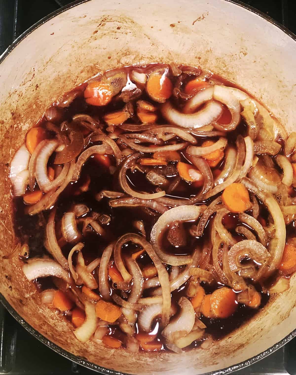 wine being added to beef daube
