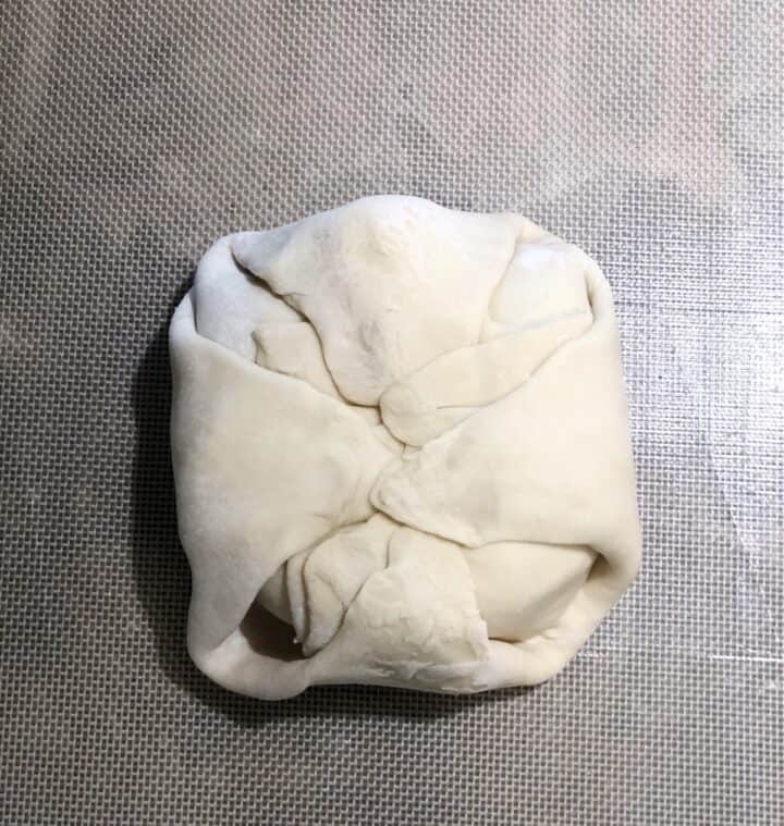 wrapping puff pastry around brie