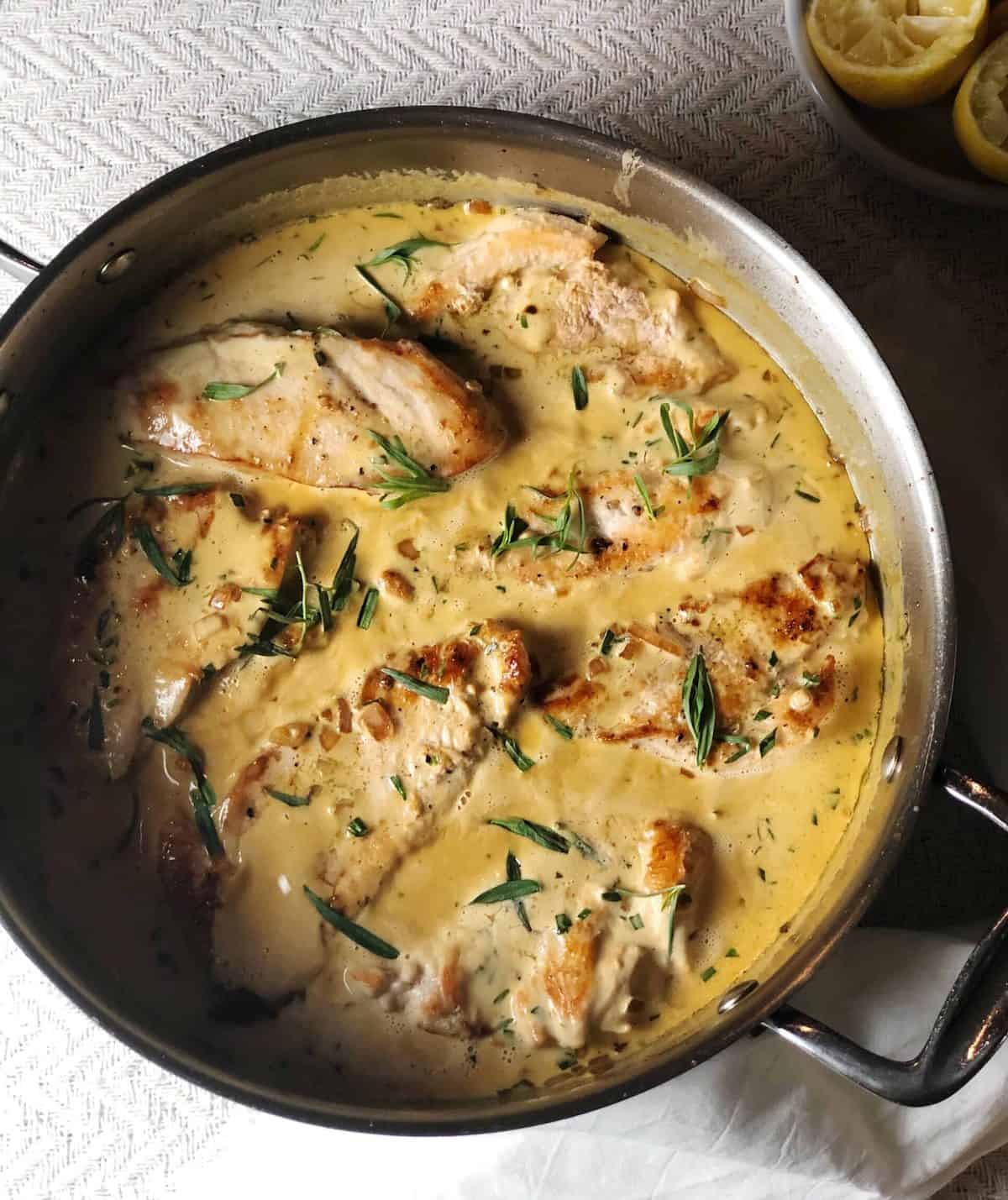chicken tarragon in pan with sauce