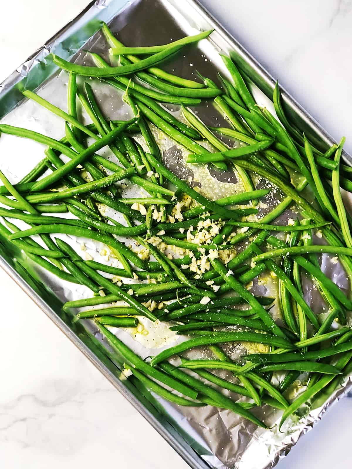 roasted garlic green beans ingredients on sheet pan