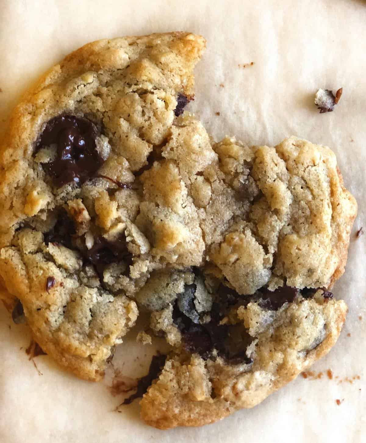 one chocolate chip oatmeal cookie with a bite taken out
