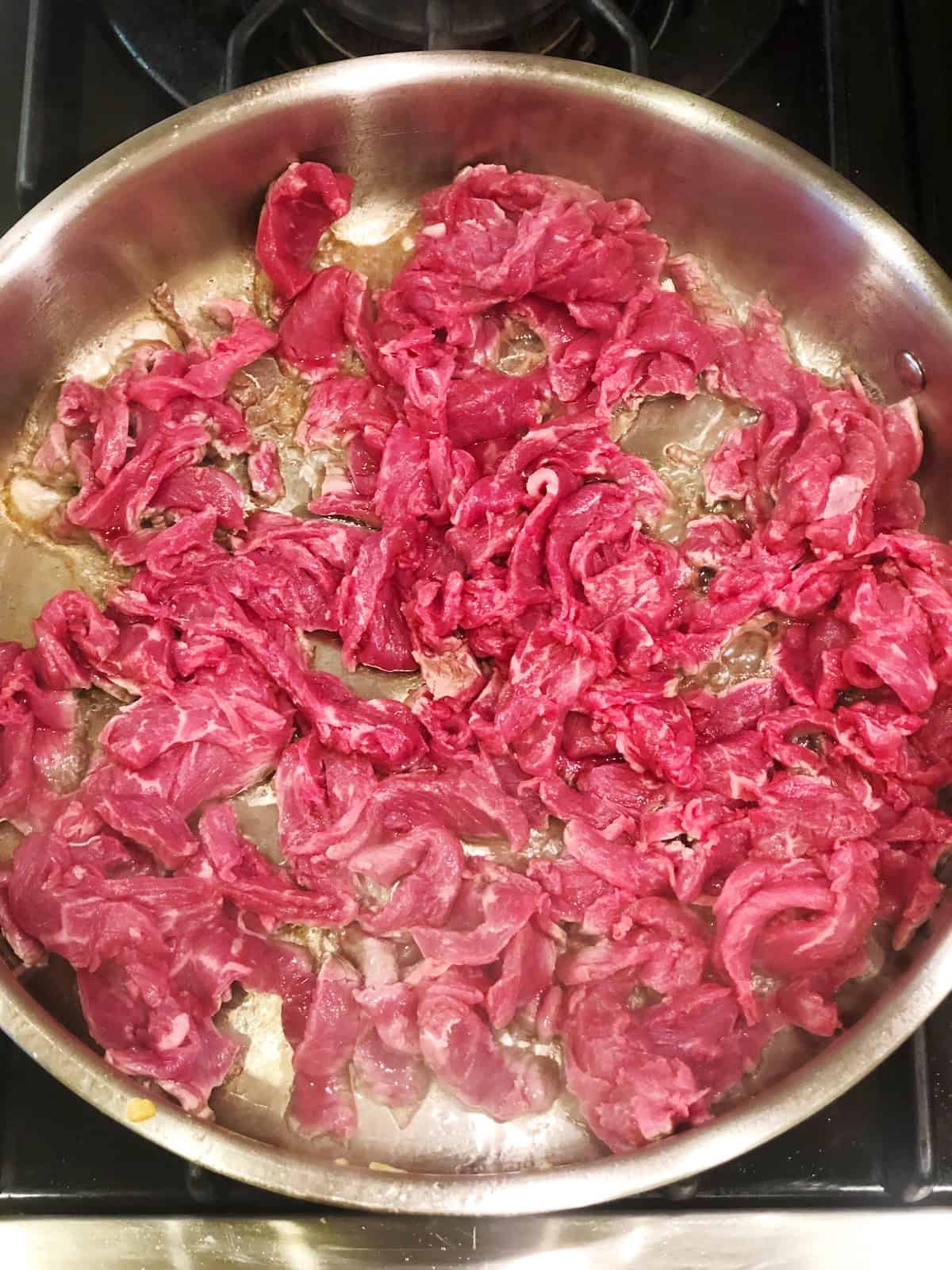 cooking steak for cheesesteak sandwich