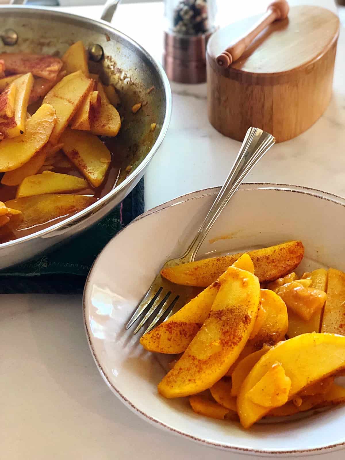 turmeric potatoes in serving bowl on table