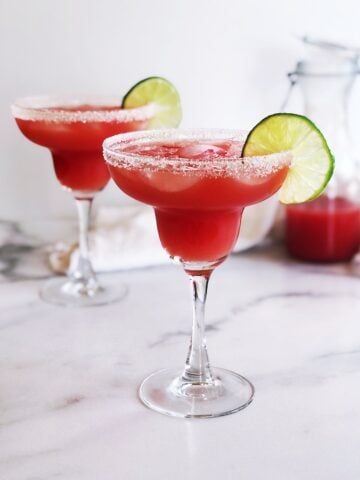 watermelon margarita in glasses with lime garnish