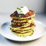 zucchini pancakes stacked up on plate