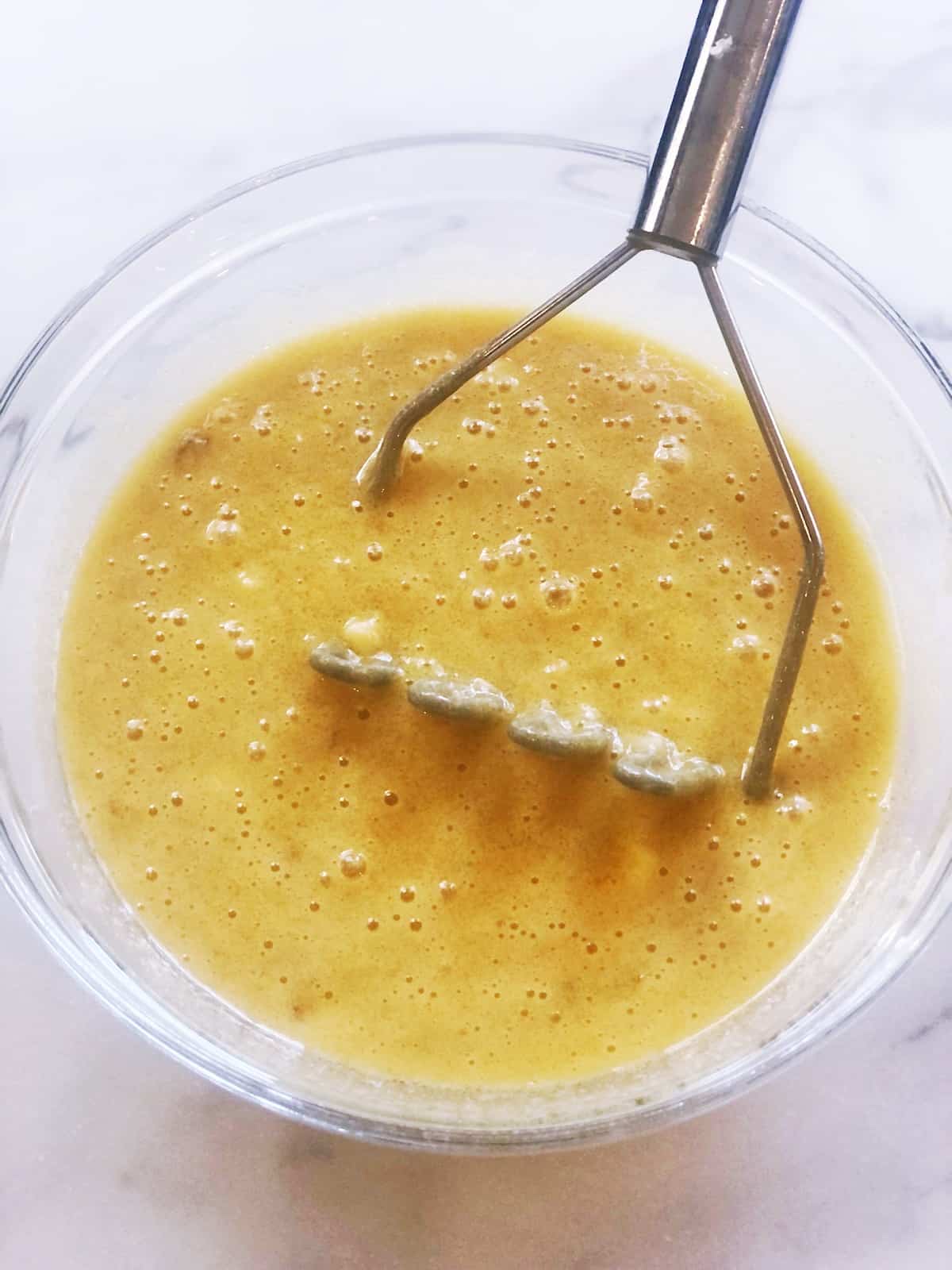 mashing banana into wet ingredients