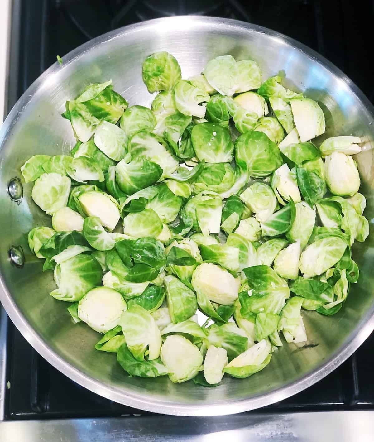 Cleaned and prepared Brussels sprouts in a pan on the stove.