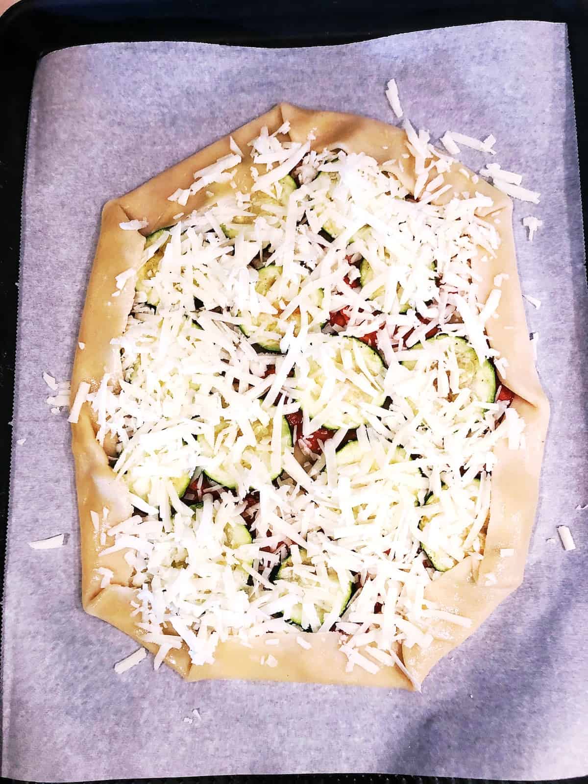 A zucchini galette on a baking sheet.