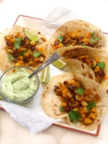 chorizo tacos on plate with avocado