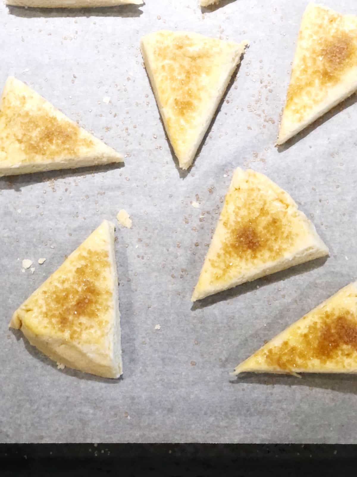 A baking sheet full of scones.