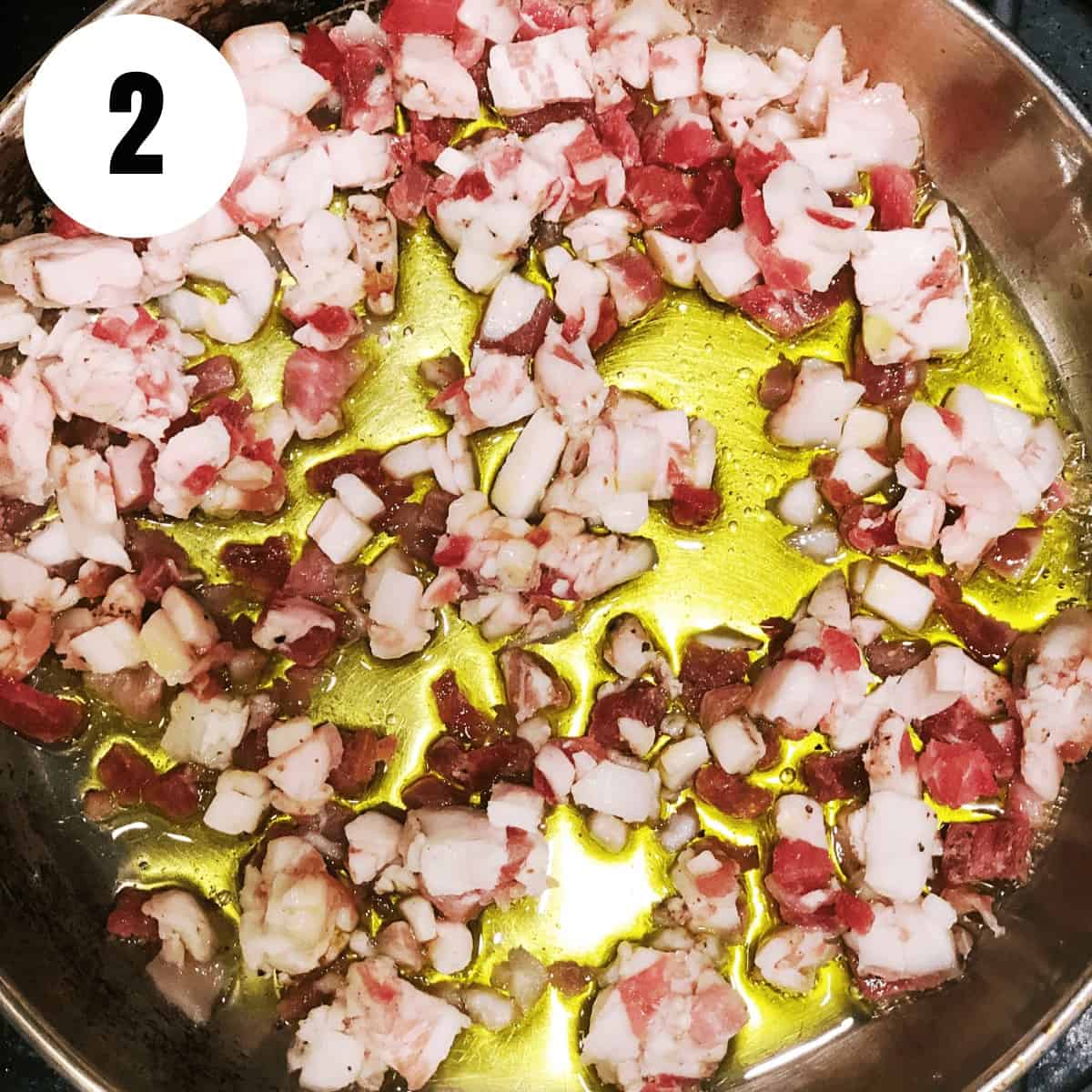 A pan with onions and garlic in it.