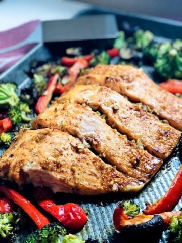 Salmon and broccoli on a baking sheet.