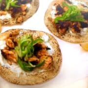 Blackened salmon tacos with yogurt sauce and lemon wedges.