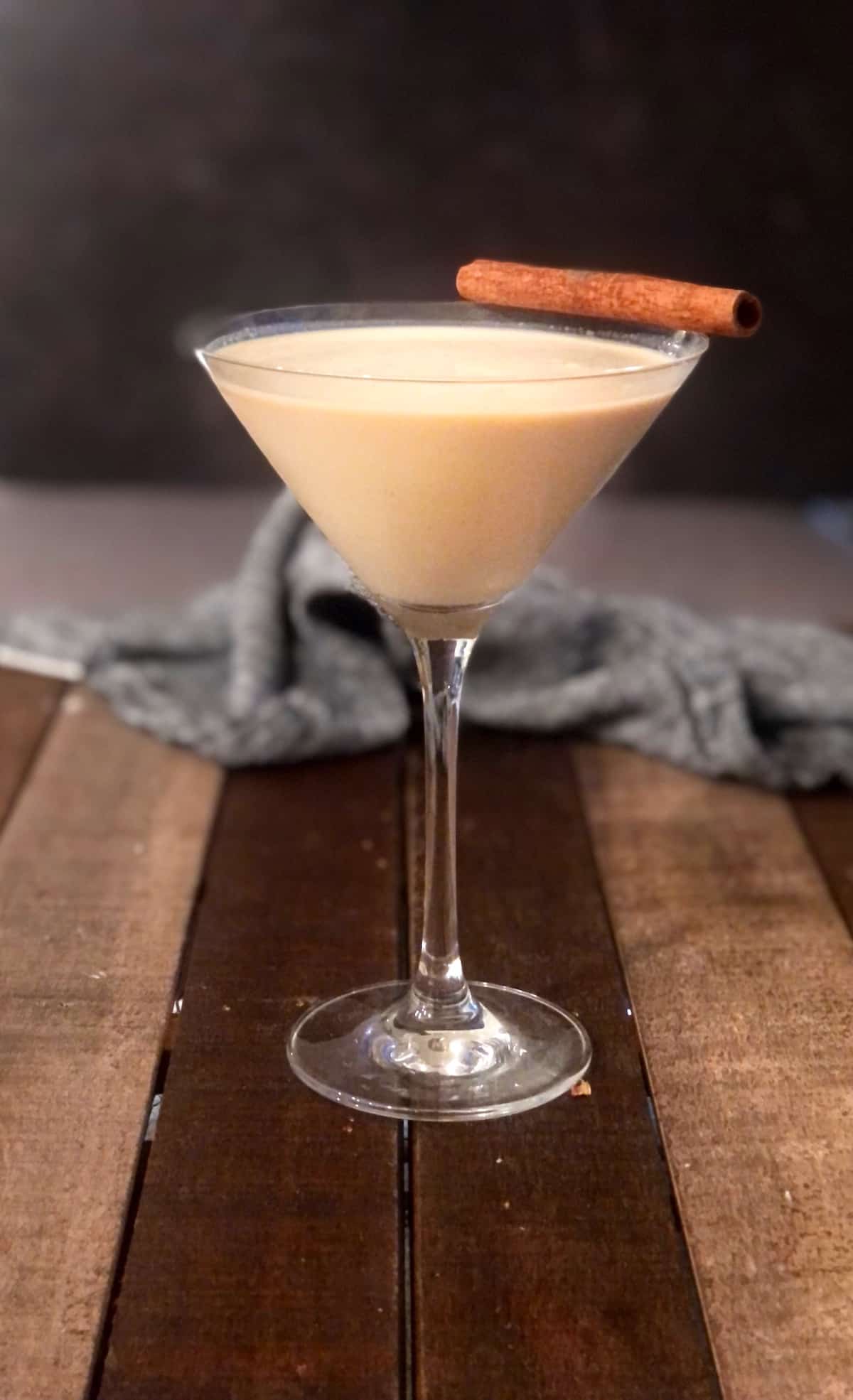 A martini with a cinnamon stick on top.
