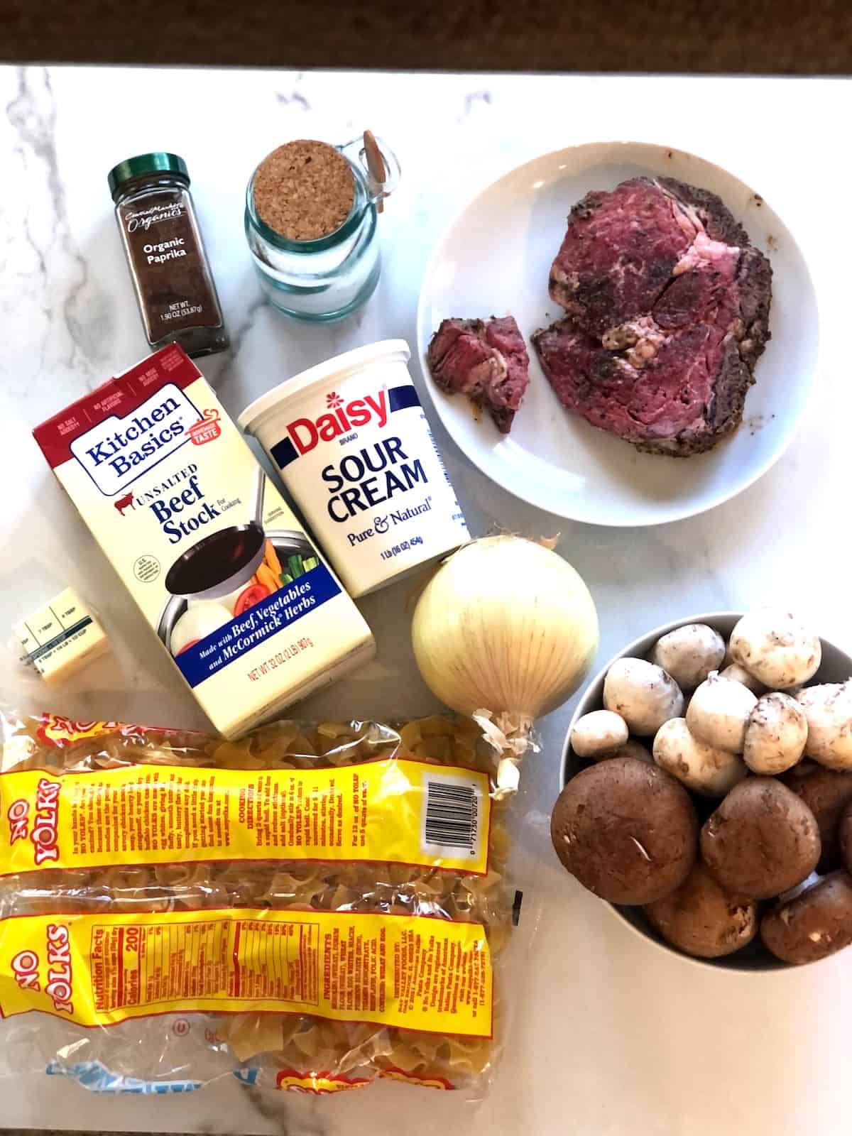 The ingredients for leftover prime rib stroganoff recipe are laid out on a table.