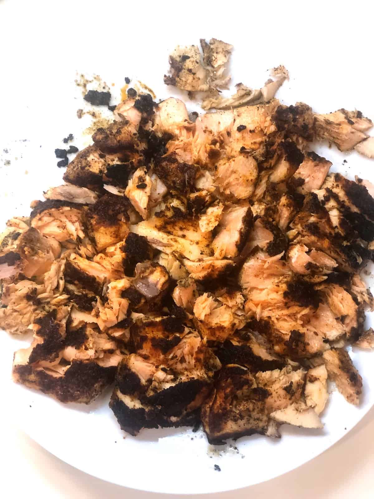 Grilled chicken on a white plate.