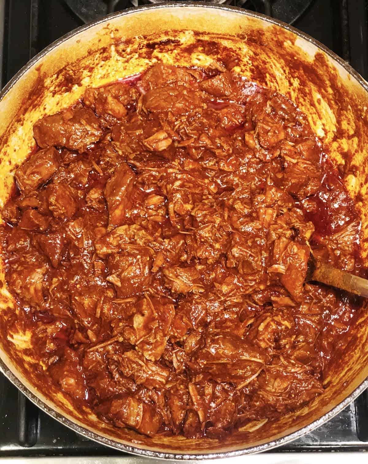 A pot with Texas chili in it on a stovetop.