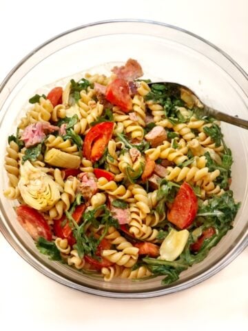 Tuna pasta salad recipe in glass bowl with a spoon