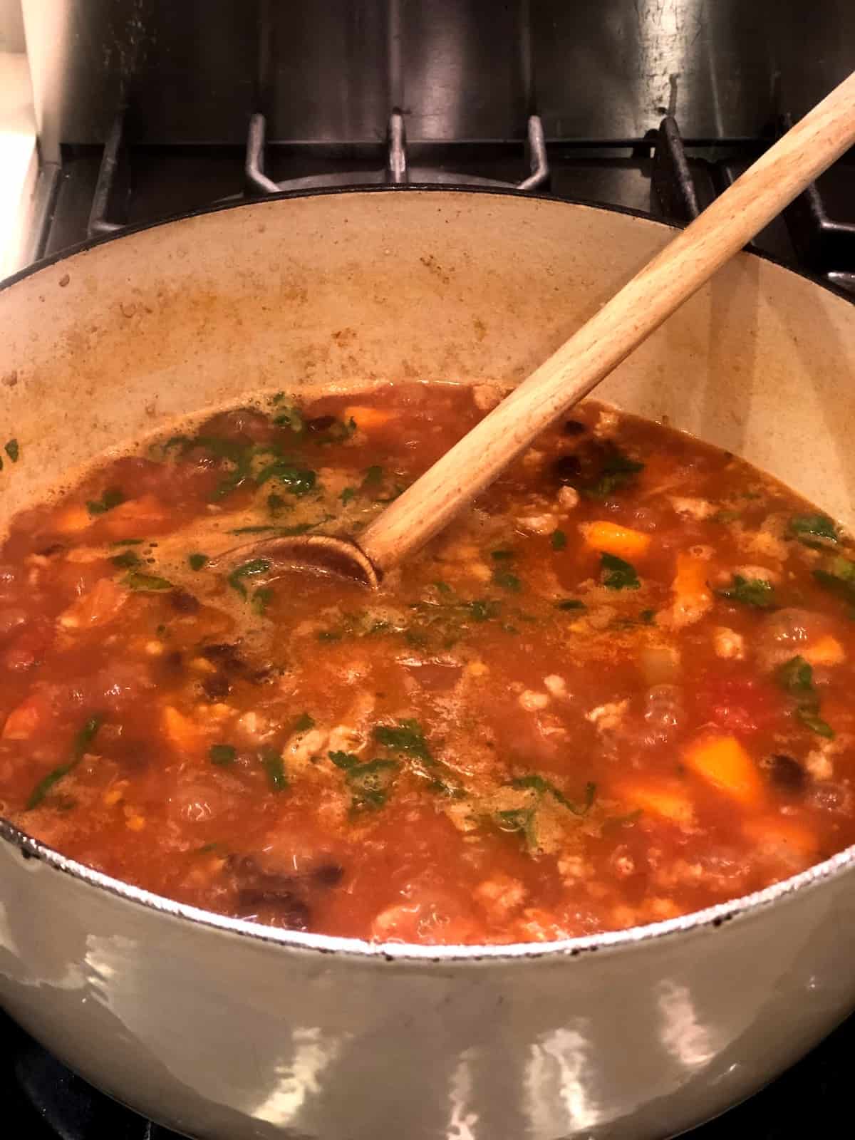 black bean sweet potato soup simmering in pot