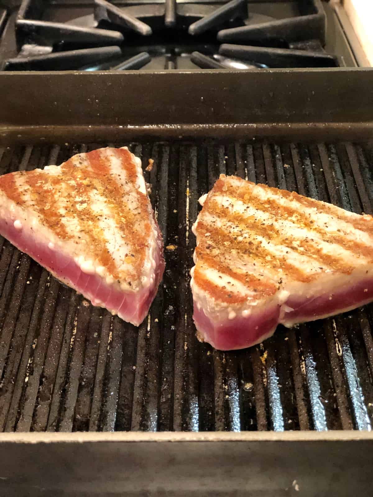 fresh tuna steaks for pasta salad cooking on the stovetop