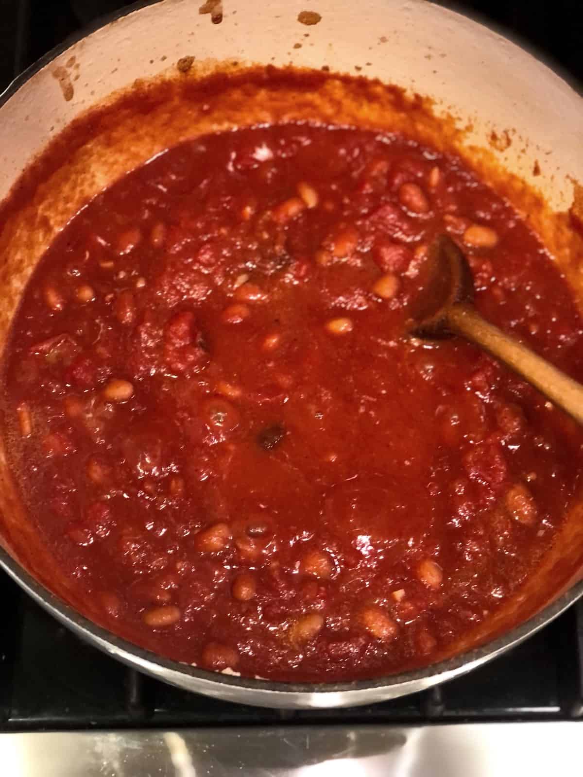 making brisket chili in a large pot on the stovetop.