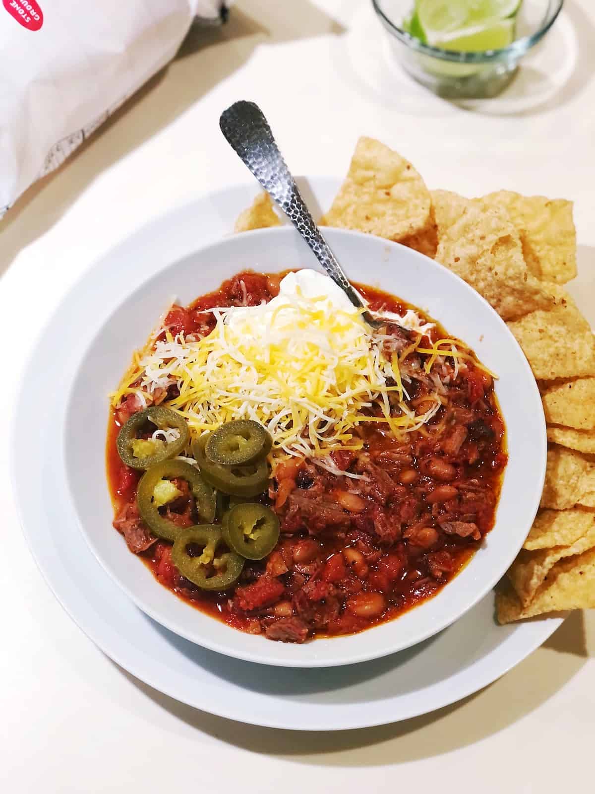 smoked brisket chili with chili toppings in a bowl