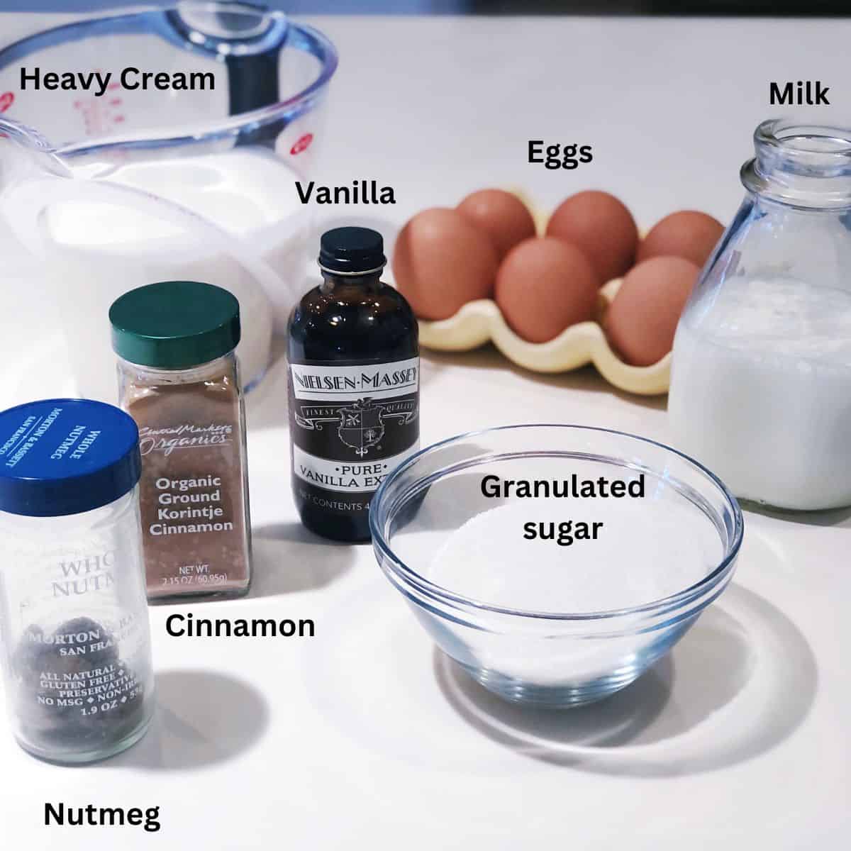 No alcohol eggnog ingredients including: milk, heavy cream, cinnamon, nutmeg, eggs, sugar and vanilla.