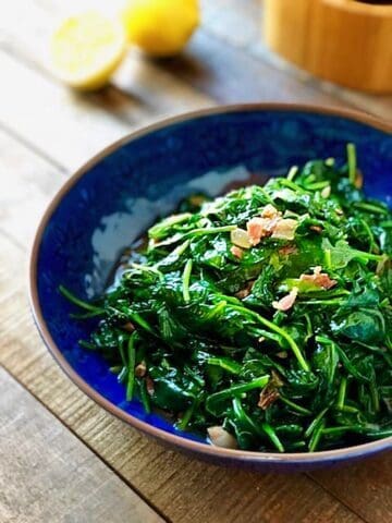 Cooked spinach in a large bowl.