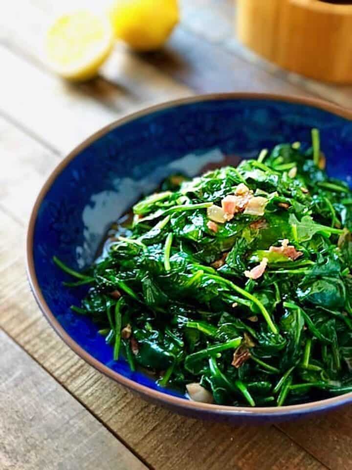 Cooked spinach in a large bowl.