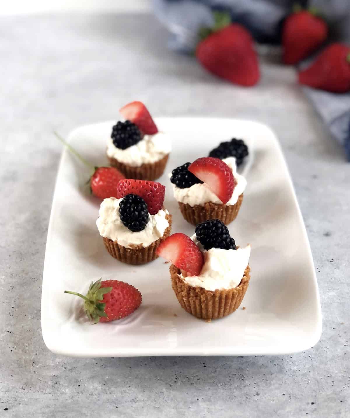 berries and cream cookie cups assembled on a plate on the counter.
