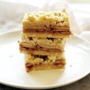 Shortbread bars on a plate stacked up.
