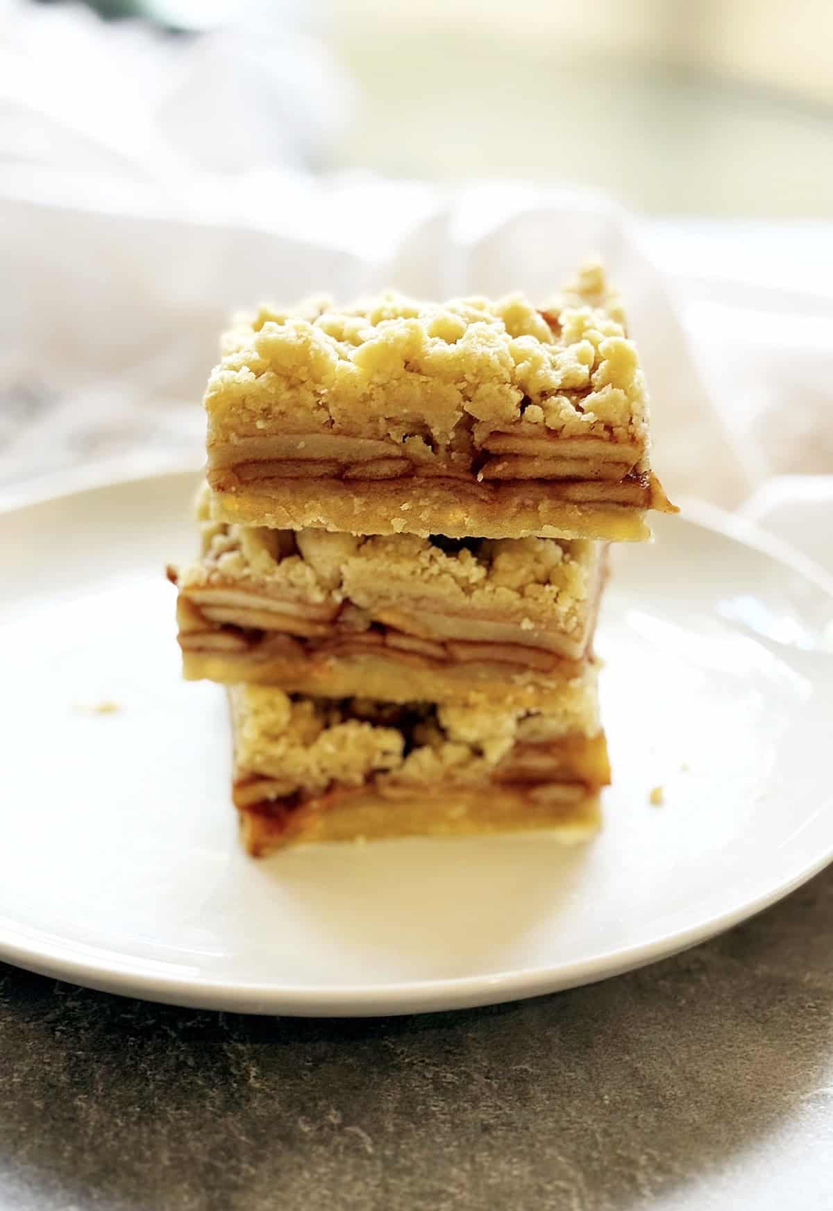 Shortbread bars on a plate stacked up.