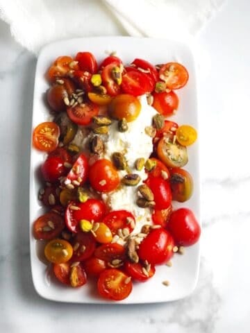 Tomato and ricotta salad on a plate.
