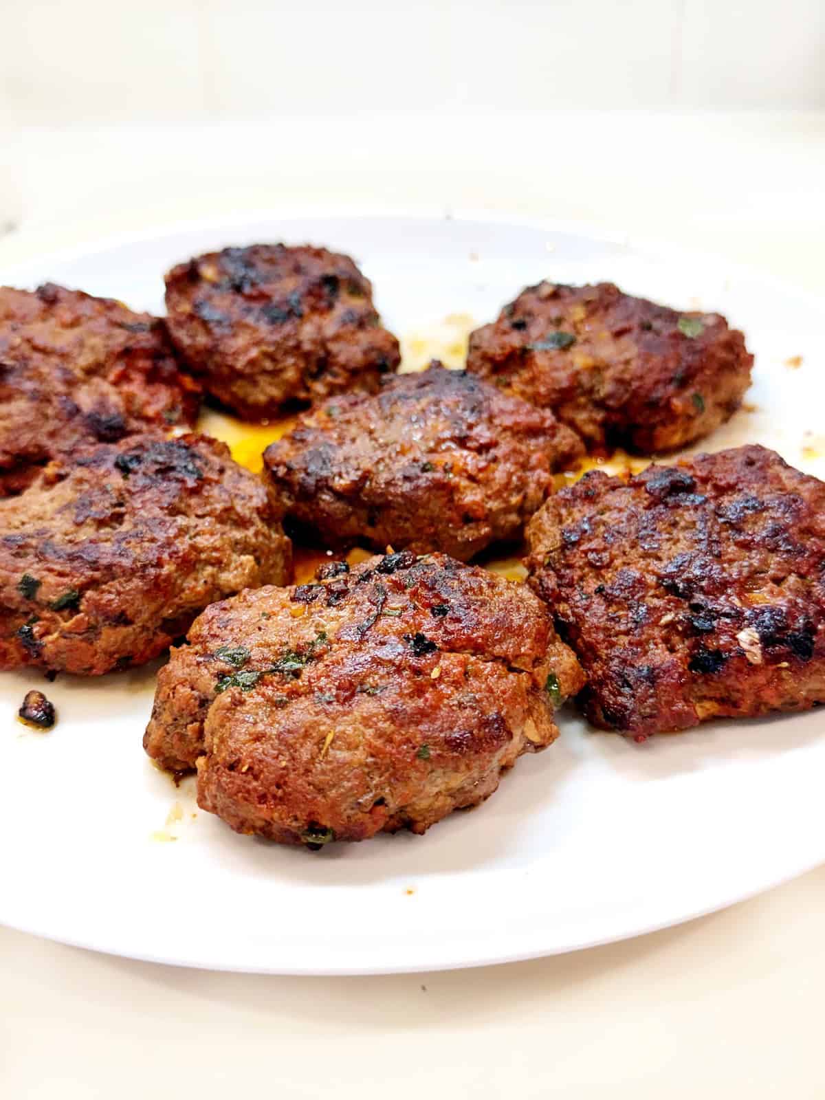 Italian herb burgers on a plate.